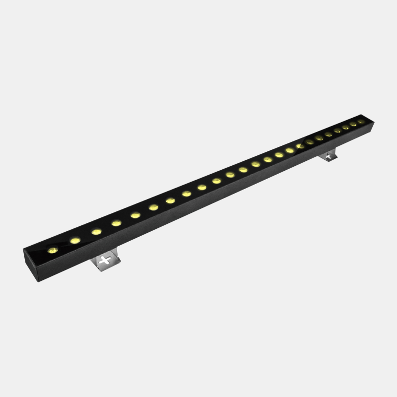 LED wall washer fixture designed to emphasize textured stone walls and brand elements, a vital architectural commercial lighting tool for commercial exteriors.